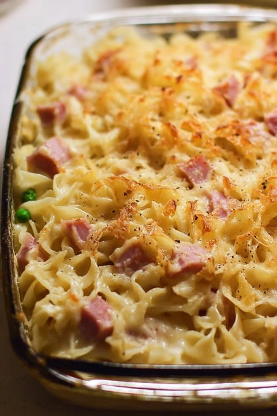 Delicious ham noodle casserole topped with cheese and baked to perfection