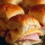 Delicious ham and cheese sliders served on a platter, perfect for appetizers.