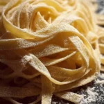 Plate of homemade fresh pasta with sauce and herbs