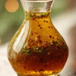 Bowl of homemade Italian dressing with fresh herbs and spices
