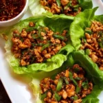 Delicious P.F. Chang's-style chicken lettuce wraps served with savory sauce.
