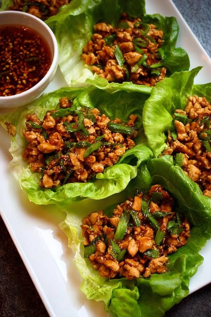Delicious P.F. Chang's-style chicken lettuce wraps served with savory sauce.