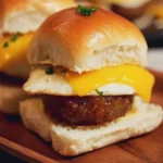 Breakfast egg and sausage sliders served on a wooden platter.