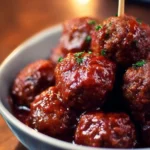 Crockpot cocktail meatballs served in a bowl with sauce