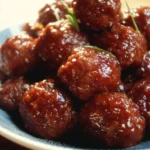 Slow cooker honey garlic meatballs in a savory sauce served with garnishes.