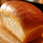 Loaf of thrifty homemade sandwich bread on a wooden cutting board