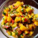 Fresh mango salsa served in a bowl with chips
