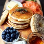 Stack of fluffy pancakes with syrup and berries on a plate