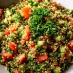 Bowl of quinoa tabbouleh salad with fresh vegetables and herbs