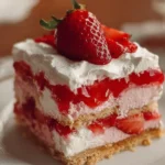 Delicious strawberry lasagna layered with cream and fresh strawberries